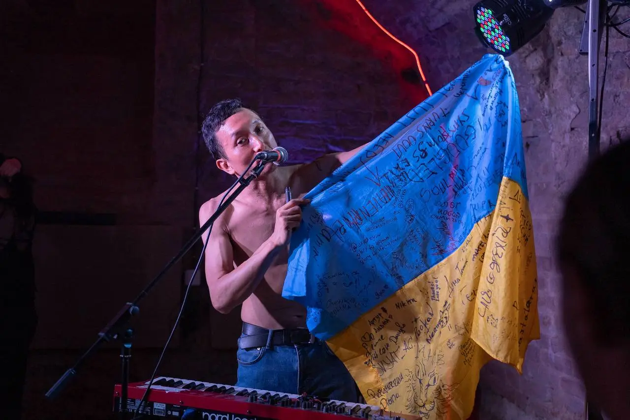 Учасник гурту Heavenphetamine Хірокі тримає прапор на концерті в Сумах