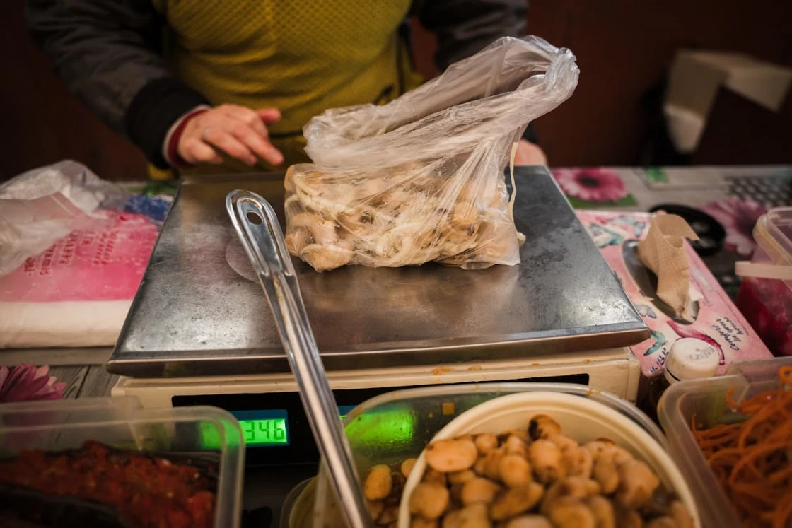 Світлана Володимирівна продає квашені гриби й пригощає іншими овочами.