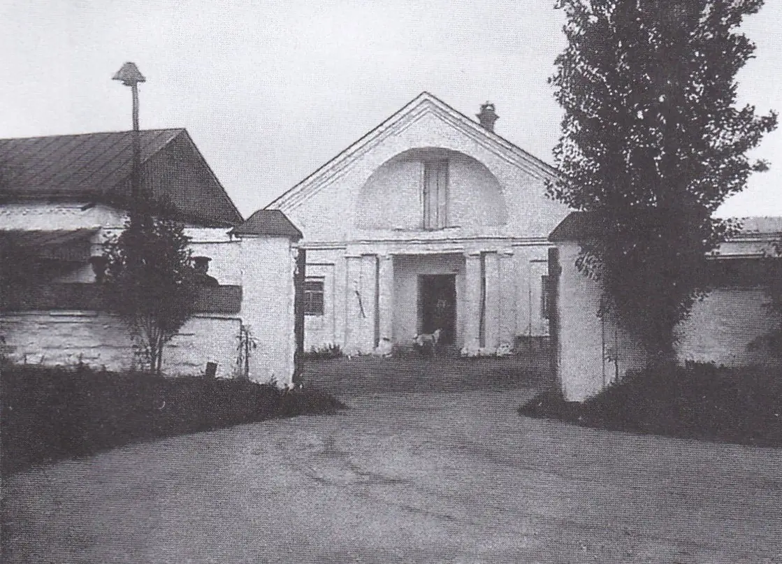 Ззаду садиби видно трикутний дашок із заглибленням усередині.